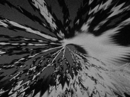 Film still from Serpent Scan by Johnny Welch. Swirling black and white image of an audio visualiser.