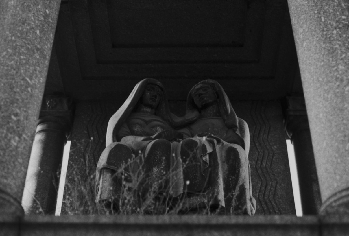 Dualism, Paris by Johnny Welch. Photograph of a two-figure statue in a graveyard